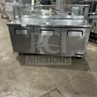 True TWT-72 commercial stainless steel 3-door worktop refrigerator with upturned backsplash, poly-coated rack, on casters.