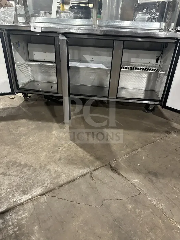 True TWT-72 stainless steel 3-door worktop refrigerator, Energy Star certified, with upturned backsplash and poly-coated racks.
