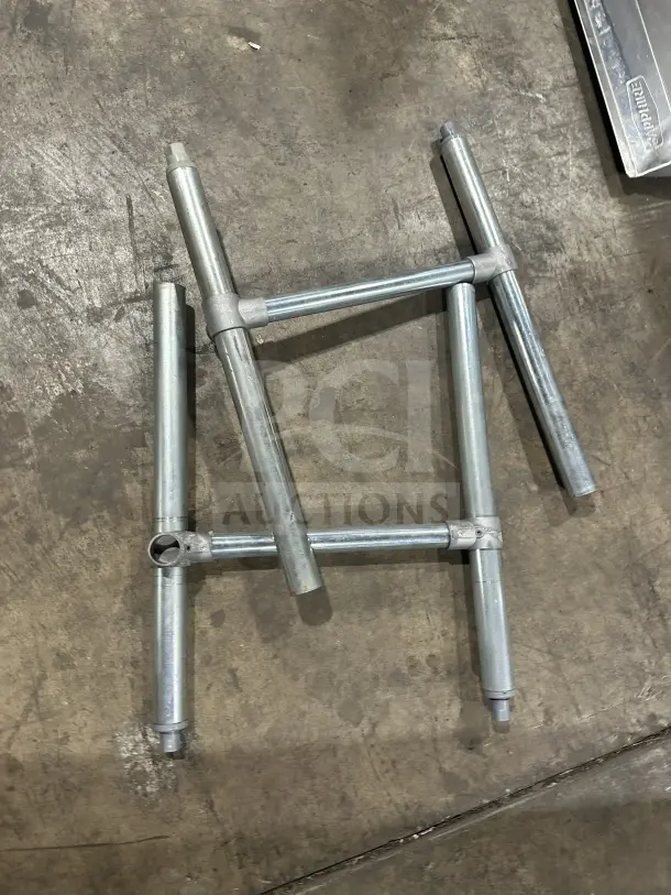Stainless steel legs for a commercial 3-compartment sink with drainboards, used condition, ready for assembly.
