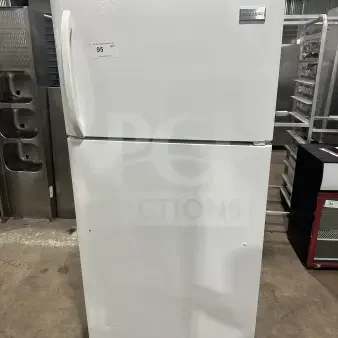 Frigidaire white top-freezer refrigerator, model FRT18G2NW9, featuring a poly coated wired rack, visible exterior dent.