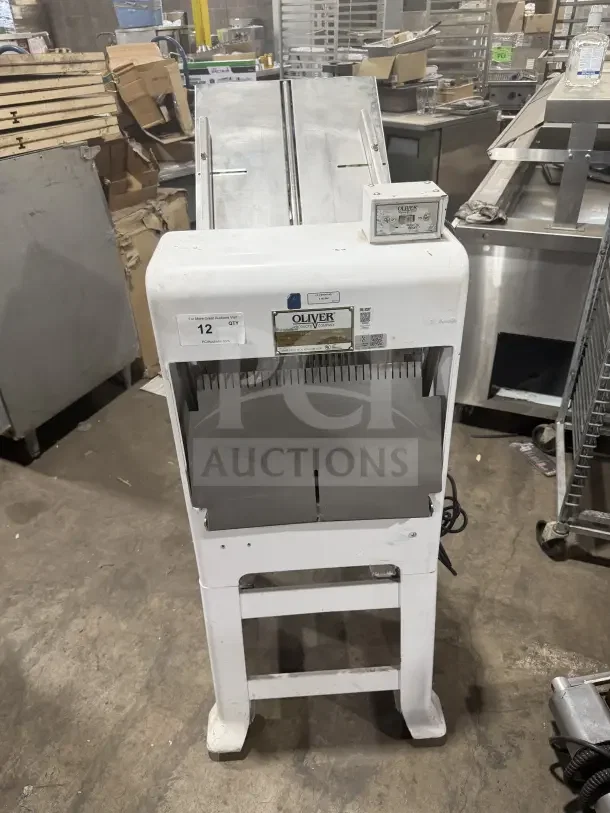 Oliver Model 79732NC bread slicer, gravity feed, white, stainless steel top, on casters, 115V, commercial use.