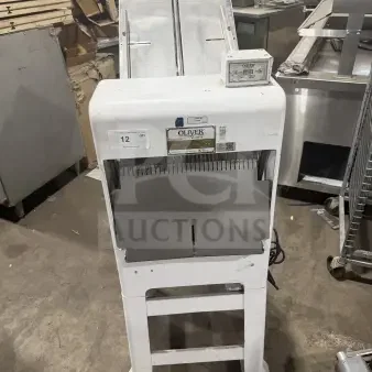 Oliver Model 79732NC bread slicer, gravity feed, white, stainless steel top, on casters, 115V, commercial use.