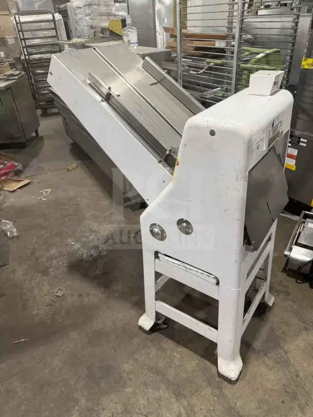 Oliver Model 79732NC white electric bread slicer with stainless steel worktop, 115V, on casters, in used condition.