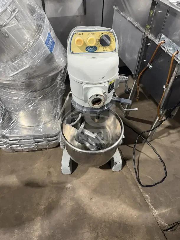 Globe white 20 Qt. commercial electric stand mixer with stainless steel bowl, showing controls and attachments.