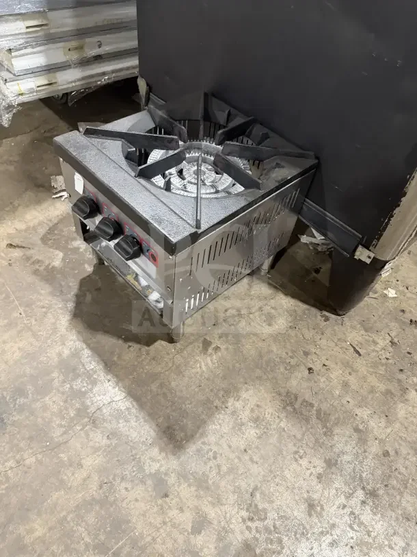 Commercial stainless steel countertop single burner stock pot range on legs, gas powered, with control knobs, in good condition.