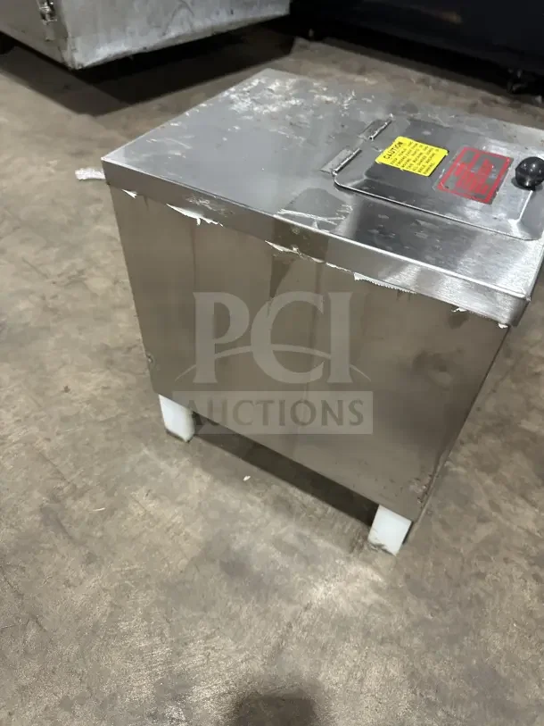 Clawson PC-2000 stainless steel electric ice crusher on legs, showing signs of wear. Model and caution labels visible on top.