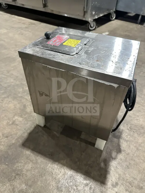 Clawson PC-2000 stainless steel electric ice crusher, 115V, 1 phase, on legs. Shows surface wear. Features safety labels.
