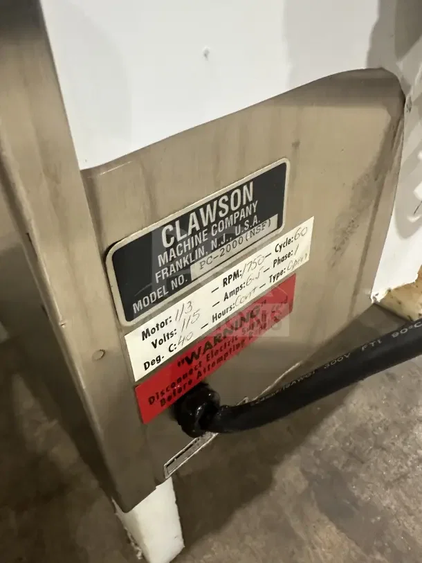 Clawson PC-2000 stainless steel countertop ice crusher, 115V, electric-powered, labeled with specs and warning.