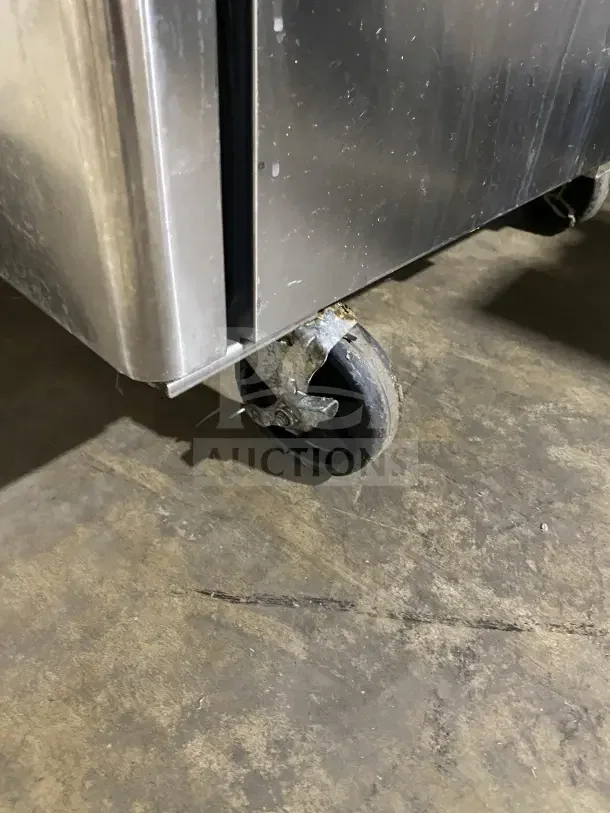 Turbo Air TST60SD refrigerated prep table on caster, stainless steel finish, showing signs of wear.