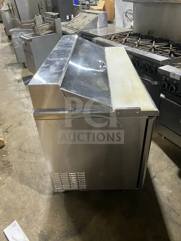 Turbo Air TST60SD stainless steel 2-door refrigerated prep table, electric-powered, with cutting board and chrome rack.