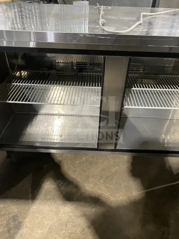 Turbo Air 60" stainless steel commercial 2-door undercounter freezer, Model MUF-60, on casters, with poly-coated wired rack.