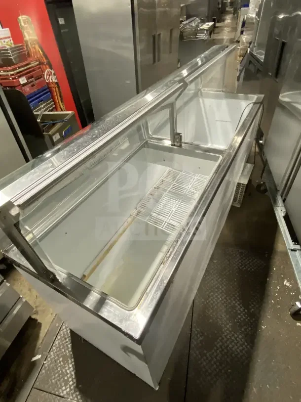 Master-Bilt commercial 69" white ice cream dipping cabinet, model DD88CG, with poly-coated wired rack, glass lid open.