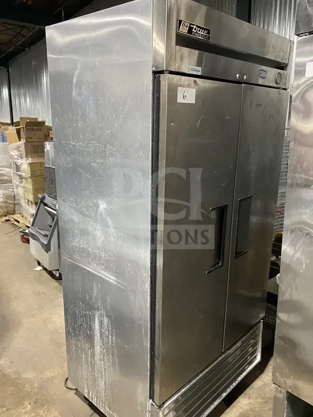 True T35F commercial stainless steel 2-door reach-in freezer, poly-coated rack, 115V, on casters, visible wear.