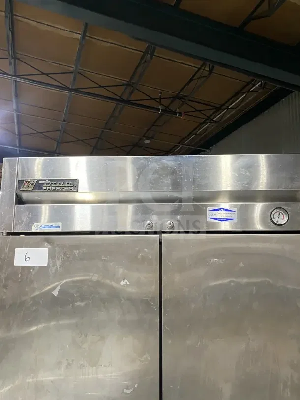 True T35F commercial stainless steel 2-door reach-in freezer with poly coated wired rack, 115V, 1 phase, on casters.