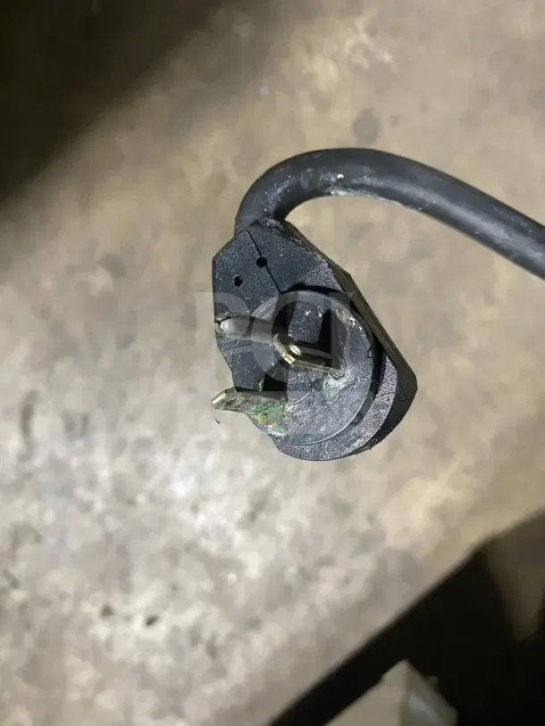 A close-up of a damaged electrical plug for a True T35F commercial freezer, showing corrosion on the prongs.
