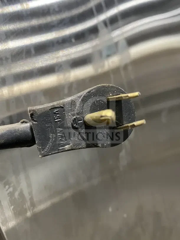 Close-up of a power plug for the Asber ARF49HFHC commercial freezer, showing a 115V plug with visible markings.