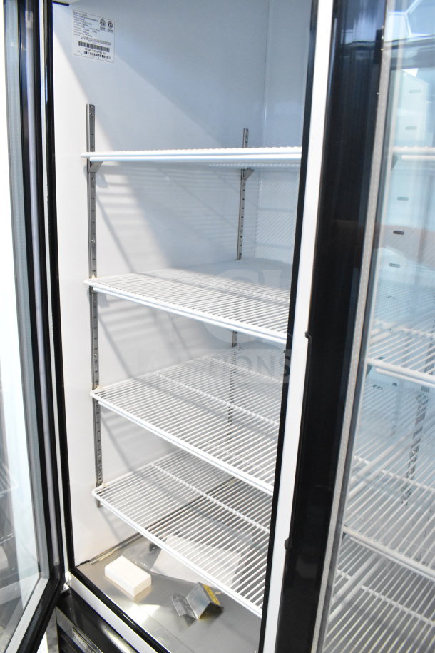 Brand new Migali C-72RM-HC three-door commercial cooler, 115V, on casters; serial visible. Some scratch and dent.