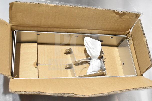 Open cardboard box containing parts for Migali C-CB72-HC commercial chef base. Includes metal frame and wrapped components.