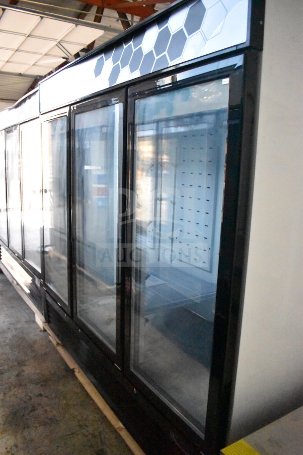 Brand new 2022 Migali C-72FM-HC commercial 3-door reach-in freezer with glass doors and black trim on casters.