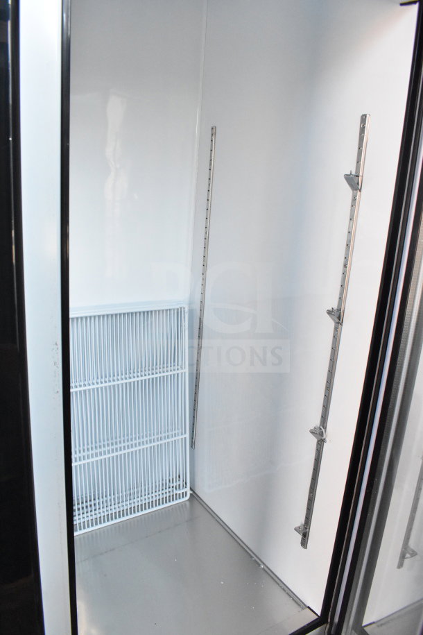 Brand new Migali C-72FM 3 Door Reach-In Freezer, scratch and dent, 115/208-230V, interior view.