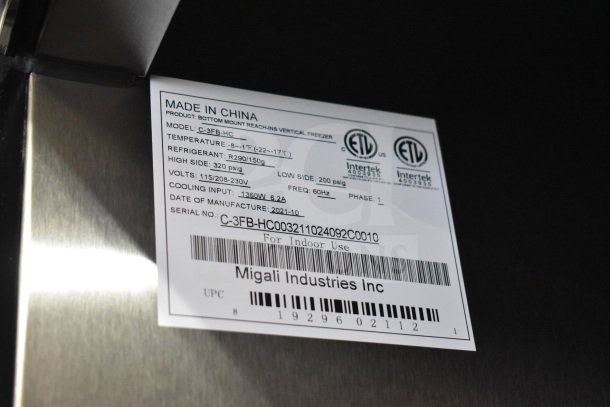 Label on a 2021 Migali C-3FB-HC commercial 3-door reach-in freezer. Shows model, voltage, and serial number details.
