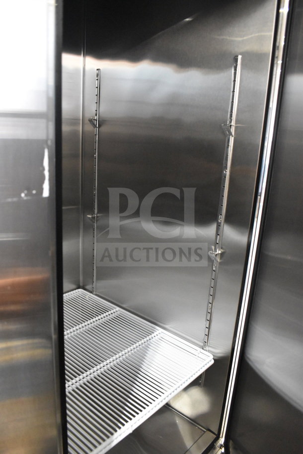 Migali C-3FB-HC 3-door freezer interior, stainless steel, new condition, visible shelves and adjustable support rails.