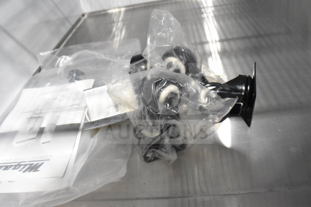 Plastic-wrapped accessories for Migali C-72FM freezer inside the unit, with instruction manual visible.