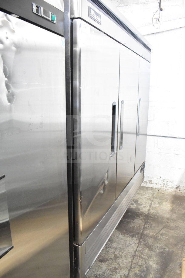 Brand new Migali C-3FB-HC 3-door reach-in freezer, 2022 model, on commercial casters, 115V, 1 phase, minor dents visible.