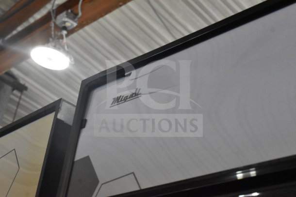Brand new Migali C-72FM-HC commercial 3-door freezer with minor scratches, label visible. Freestanding on casters.