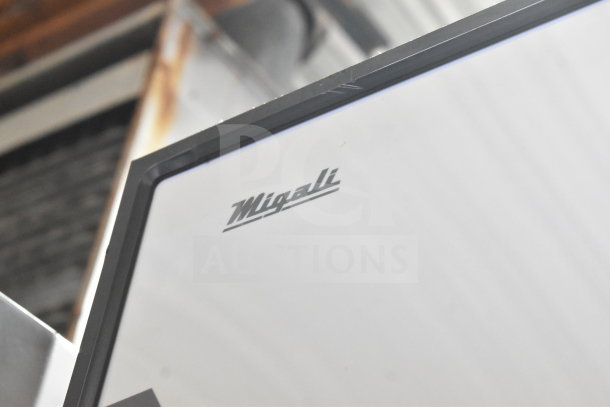 Migali C-3R-HC 3 Door Reach In Freezer top view, brand logo visible, new condition with minor scratches.