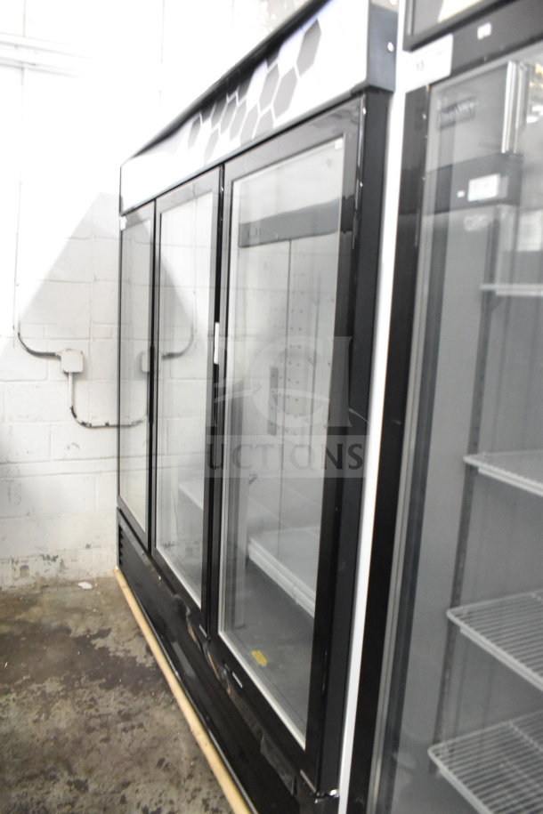 "Brand new Migali C-72FM-HC three-door commercial freezer, scratch and dent, on casters, 115/208-230V, 1-phase."