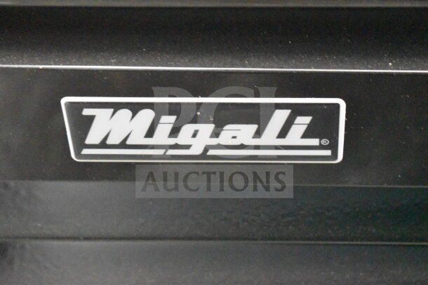 Brand logo "Migali" on the 2022 Migali C-72FM-HC 3-Door Reach-In Freezer Merchandiser with commercial casters.