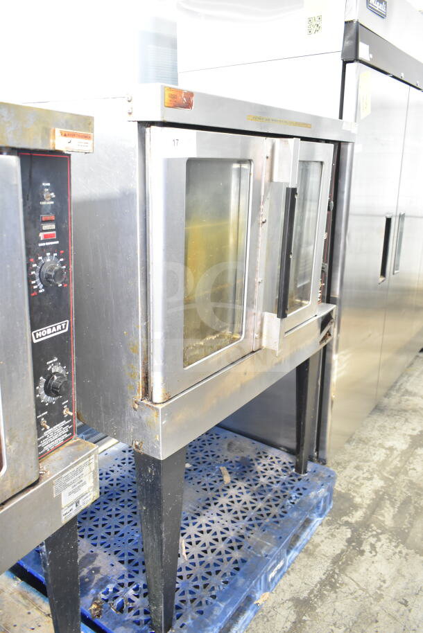 Hobart full-size convection oven with view-through doors, thermostatic controls, and metal legs. Visible wear.