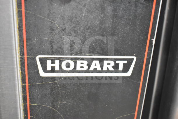 Hobart logo on a commercial convection oven, featuring view-through doors, thermostatic controls, and metal legs.