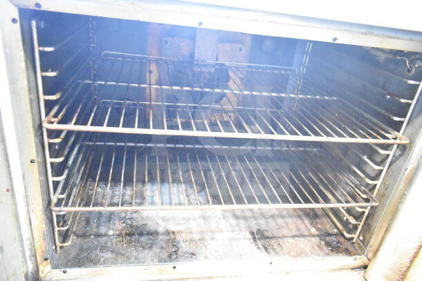 Hobart commercial full-size convection oven with view-through doors, thermostatic controls, and metal legs. Interior shows moderate use.