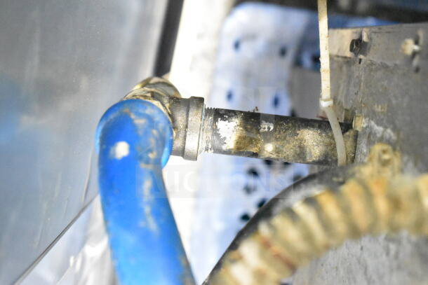 Hobart commercial convection oven detail showing blue hose and metal connection, highlighting part of the unit's setup.