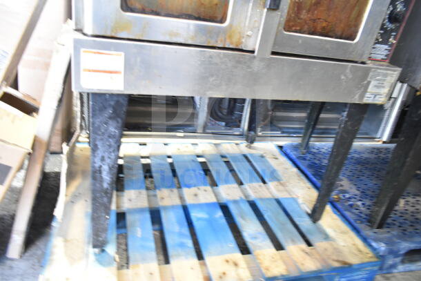 Hobart commercial convection oven with view-through doors, thermostatic controls, metal legs; visible wear and surface marks.