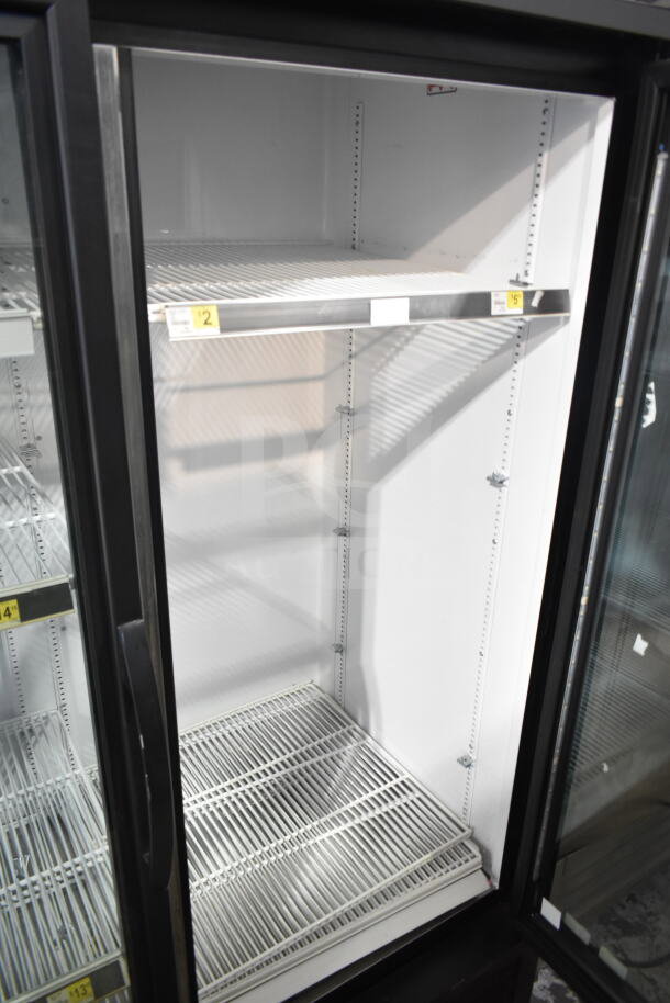 2019 True GDM-49-HC commercial cooler; 2 glass doors, 115 volts, white interior, shelves visible, excellent condition.