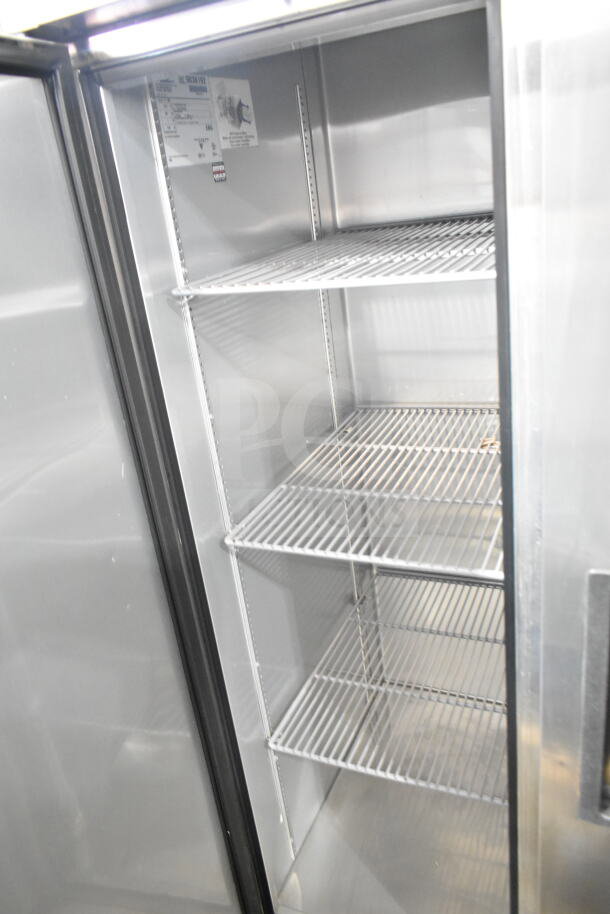 2017 True T-35 commercial 2-door reach-in cooler, 115V, 1 phase, excellent condition, interior view showing shelves.