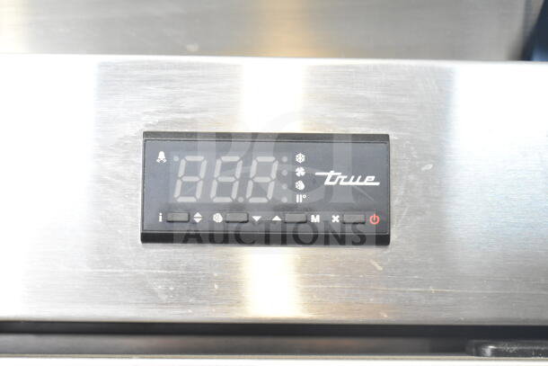 Alt Text: Control panel of a 2022 True T-35-HC Commercial 2 Door Reach In Cooler, displaying digital temperature and brand logo.