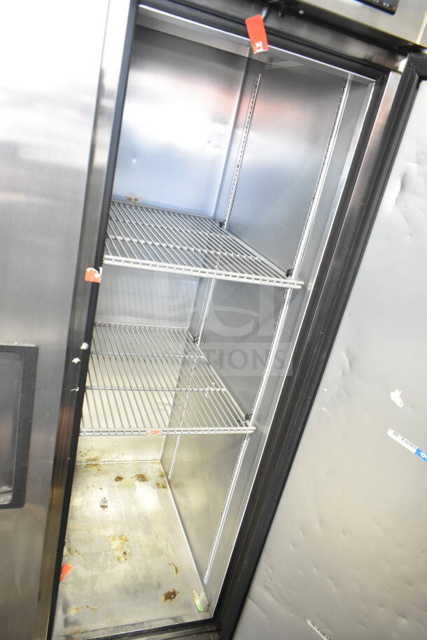 2022 True T-35-HC Commercial 2 Door Cooler, 115 Volts, 1 Phase, clean interior, visible shelving, some wear on base.
