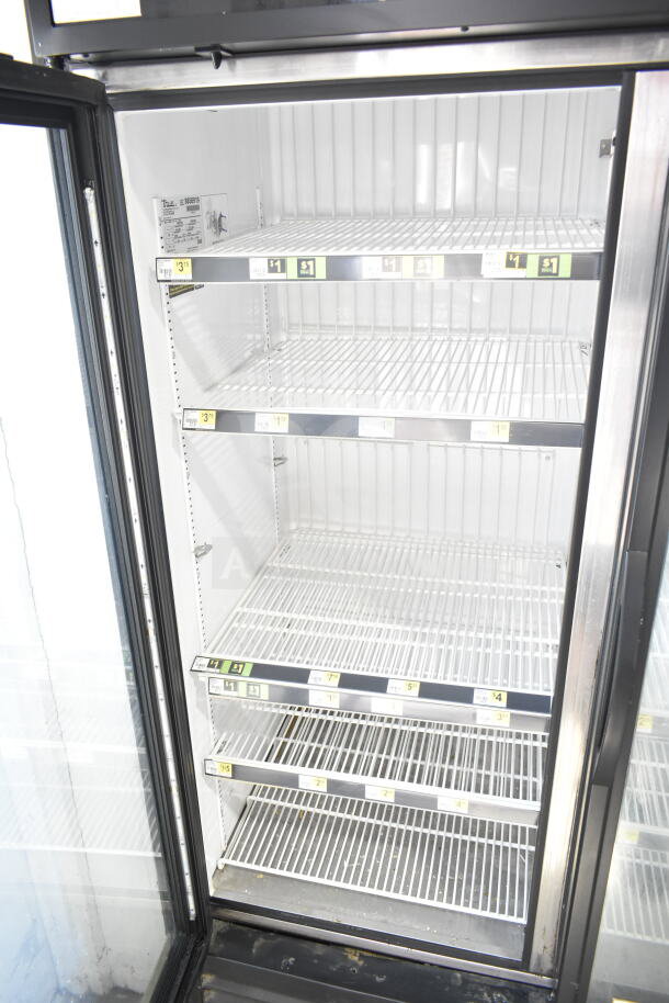 2016 True GDM-72F-HC 3 Door Reach In Freezer, well-maintained, with visible shelves and labeling. 115/208-230V, 1 Phase.
