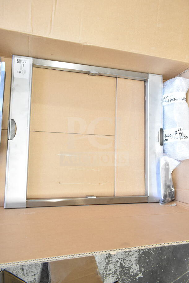 Brand new Fri-jado Spit Trolley Large in box, stainless steel, some scratches and dents visible, includes branding label.