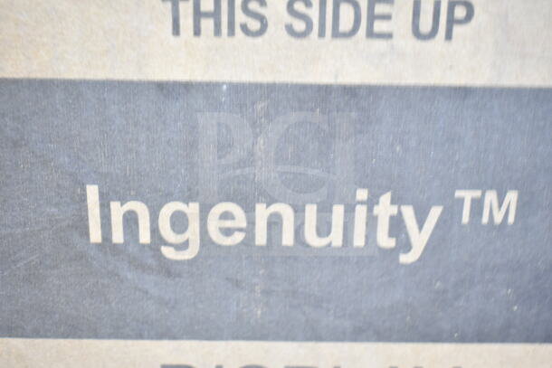 Cardboard box marked "THIS SIDE UP" and "Ingenuity™" label, indicating the brand of the bouncer inside.
