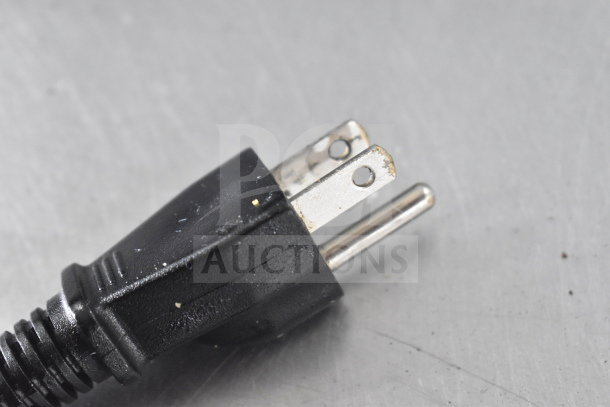 Close-up of a black power plug for Proctor Silex GR05 Commercial Rice Cooker, 120 Volts, 1 Phase. Plug shows minor wear.