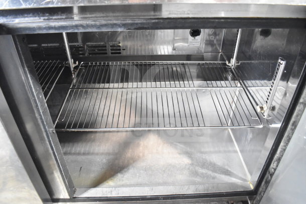 Turbo Air TWR-60SD commercial cooler interior, showcasing ample shelving space, stainless steel finish, and commercial casters.