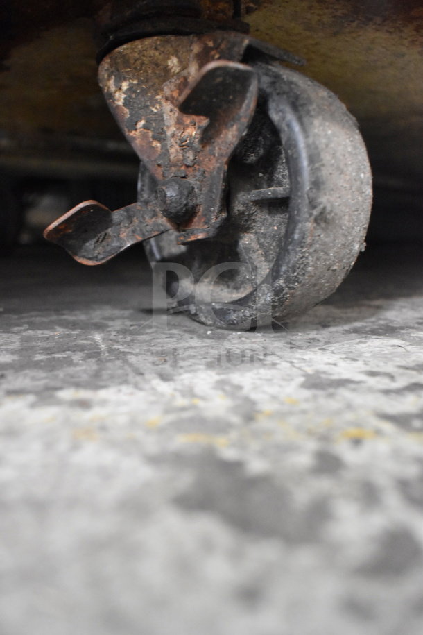 Close-up of a rusted commercial caster on a Turbo Air TWR-60SD Undercounter Cooler. 115 Volts, 1 Phase.