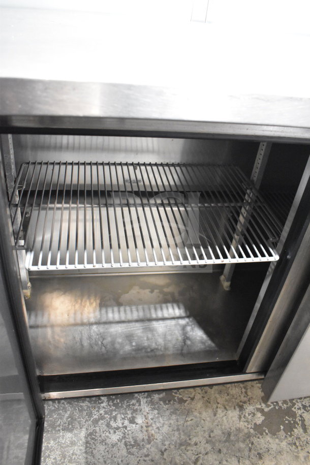 True TUC-72 commercial 3-door undercounter cooler with shelving, on commercial casters. 115 volts, 1 phase, clean interior.