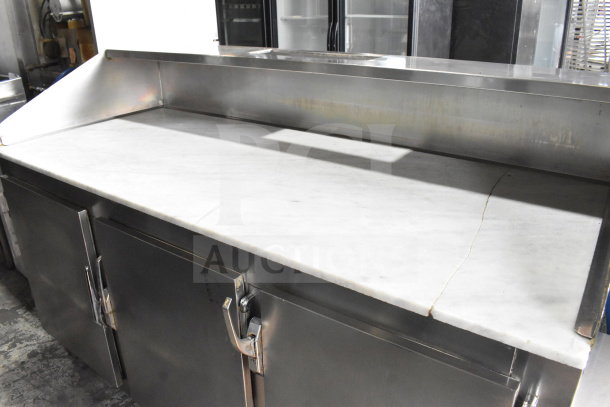 Commercial 3-door cooler with stone countertop, stainless steel finish, on commercial casters; ideal for kitchens.