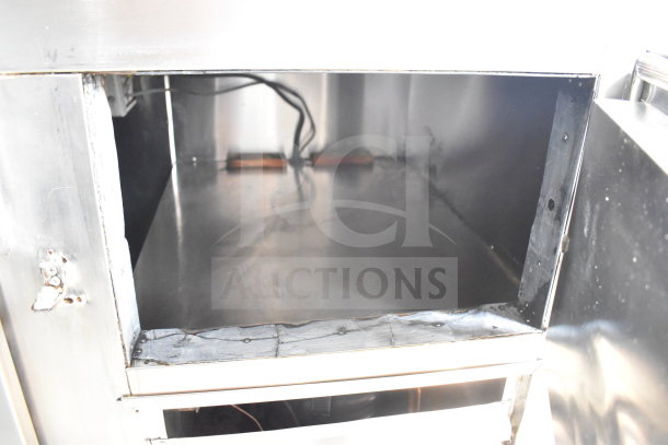Commercial 3-door cooler with stone countertop on casters, visible interior structure, stainless steel, durable design.